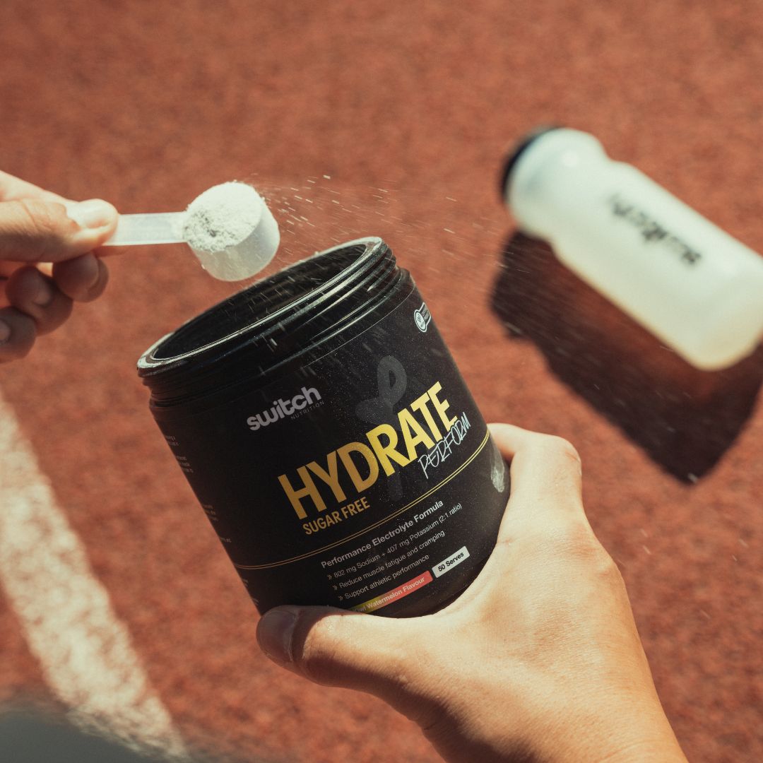 Switch Nutrition Hydrate Perform Sugar Free electrolyte powder tub showing hydration supplement with sodium, potassium, taurine and vitamins for performance hydration